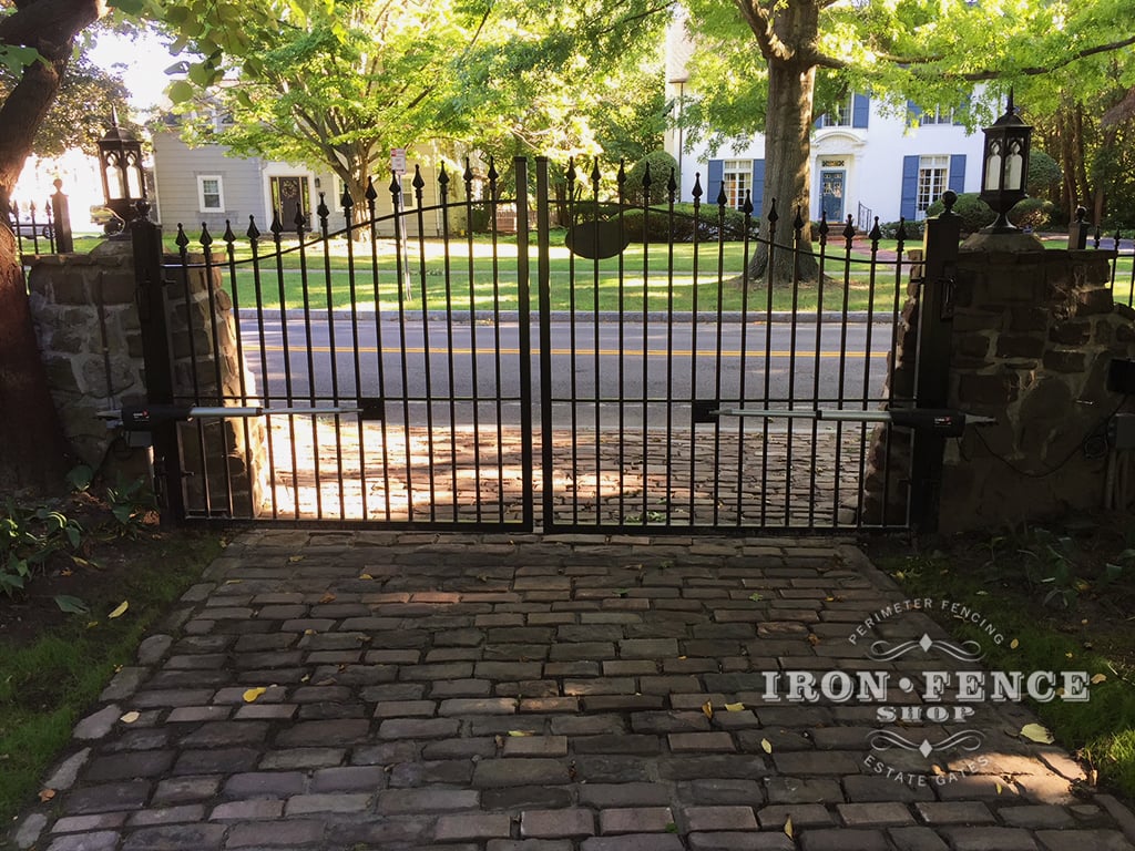 Our Classic Iron Driveway Gate Installed Behind Stone Columns