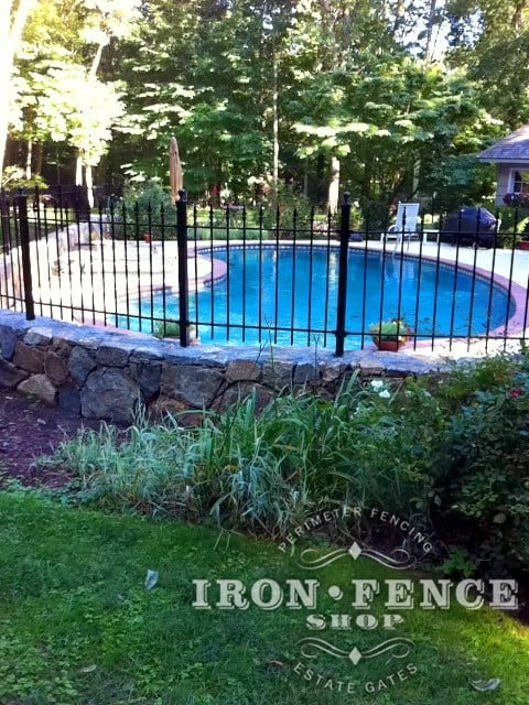 Wrought Iron Fence Installed on a Stone Wall around a Pool and Curved with Angle Brackets (3ft Tall Classic in Traditional Grade)