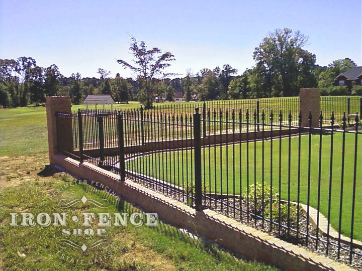Our Classic Style Iron Fence Mounted on a Brick Wall with Columns Using Flange Posts