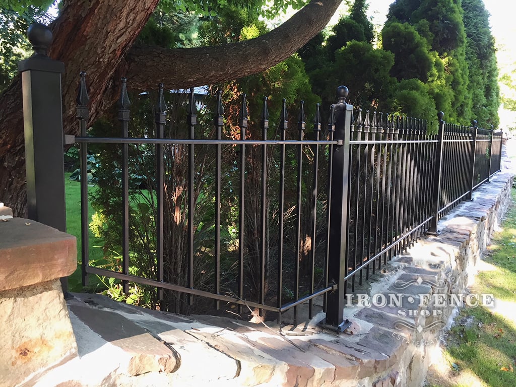 3ft Iron Fence Panel Installed on a Stone Wall Top with Flange Posts