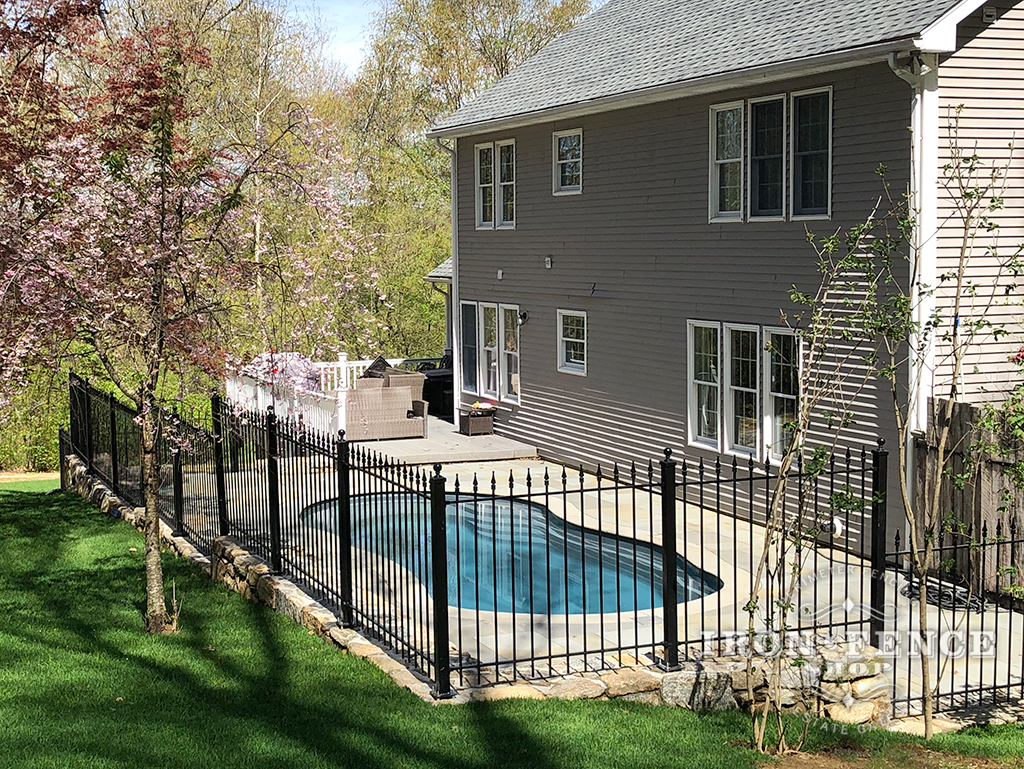 Our 4ft Tall Classic Iron Fence Installed on a Stone Wall Surrounding a Pool