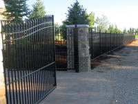 20ft Wide Iron Double Gate (two 10ft halves) in a 6' Arching to 7' Height Installed with Decorative Columns