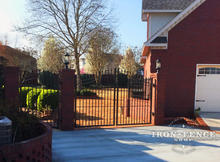 Wrought Iron Gate in a 10ft W x 6ft to 7ft H Size Installed Between Brick Pillars