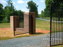 14ft Wide Signature Grade Iron Driveway Gate with 6ft to 7ft Profile - Mounted on Steel Posts Between Brick Pillars (Style #1: Classic)