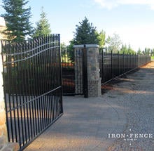 20ft Wide Iron Double Gate (two 10ft halves) in a 6' Arching to 7' Height Installed with Decorative Columns