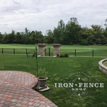 3ft Tall Signature Iron Fence Panels with Custom Gate Installed on a Brick and Stone Wall Top