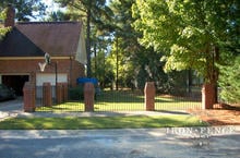4ft Tall Wrought Iron Fence in Traditional Grade Installed Between Brick Pillars
