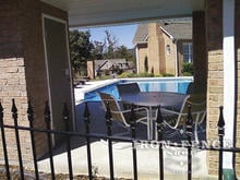 Our Classic Style Iron Fence with Finial Tips Around a Serene Pool Setting