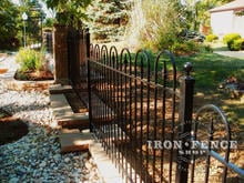 4ft tall iron hoop and picket style fence stepped down a knee wall