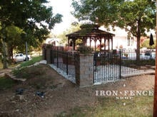 4ft tall iron hoop and picket fence panel with stone columns 