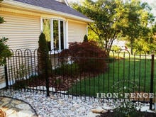 4ft tall wrought iron hoop and picket style fence with landscaping gravel underneath