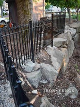 4ft Signature Grade Classic Iron Fence Installed Along a Stone Wall/ Barrier