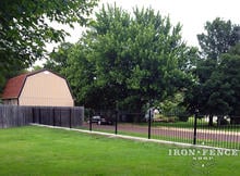 4ft Tall Classic Style Wrought Iron Fence Installed on a Curb Top with Flange Posts (Traditional Grade)