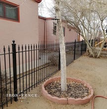 4ft Iron Fence Running Along a Southwestern Styled Home