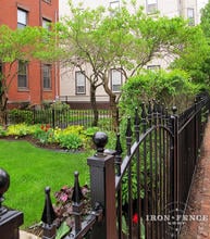 Beautiful Front Garden Accented with a 4ft Tall Wrought Iron Fence and Arch Gate in Traditional Grade