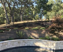 5ft Tall Wrought Iron Fence in Puppy Picket Style Stepped Around a Pool