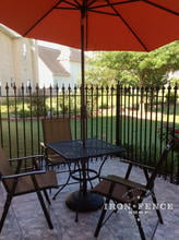 Beautiful use of Stronghold Iron Fence and Gate installed around a back Patio