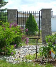 5ft Tall Traditional Grade Wrought Iron Gate Mounted Between Stone Pillars