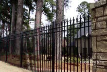 6ft Tall Signature Grade Iron Fence Used in Conjunction with Stone Masonry Pillars in a Front Yard Enclosure (Style #1: Classic)