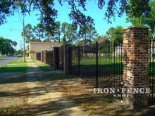 6 foot tall iron fence with custom triad finials and mounted between brick columns (Based on Style #1 - Classic)
