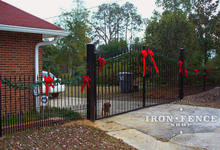 16ft wide iron driveway gate in a 6ft to 7ft height with puppy pickets and matching 4ft tall fence