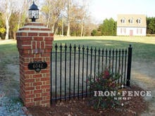 Custom Arched Entryway Iron Fence Panel on Brick Pillar