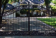 Closer view of a custom iron arched driveway gate (6ft to 7ft arch height) with welded in decorative castings