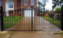 Custom iron driveway gate with letter initials and customer painted gold accents (Based on Style #16 - Rings Puppy Picket)