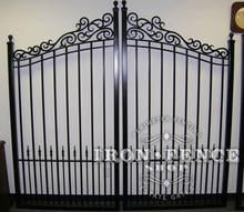 Custom iron driveway gate with scroll work top design and puppy pickets