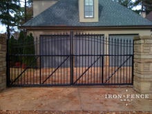 Custom slide gate system with iron arch gate welded to tubular slide frame