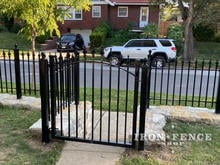 Iron Arched Entry Gate Paired with Matching Iron Fence
