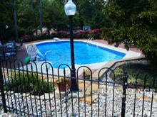 4ft tall Iron hoop and picket style fence in Traditional grade around a pool