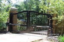 Ranch Style Iron Driveway Gate in a 12ft Width Mounted Behind Columns