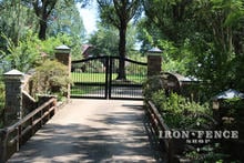 Ranch Style Arched Iron Driveway Gate with Columns