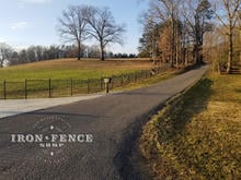 5ft Tall Iron Fence Stair-Step Installation Down a Slope
